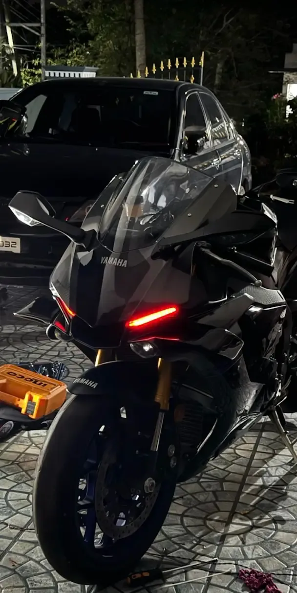 Black Yamaha R-series sportbike with custom LED turn signals and gold forks