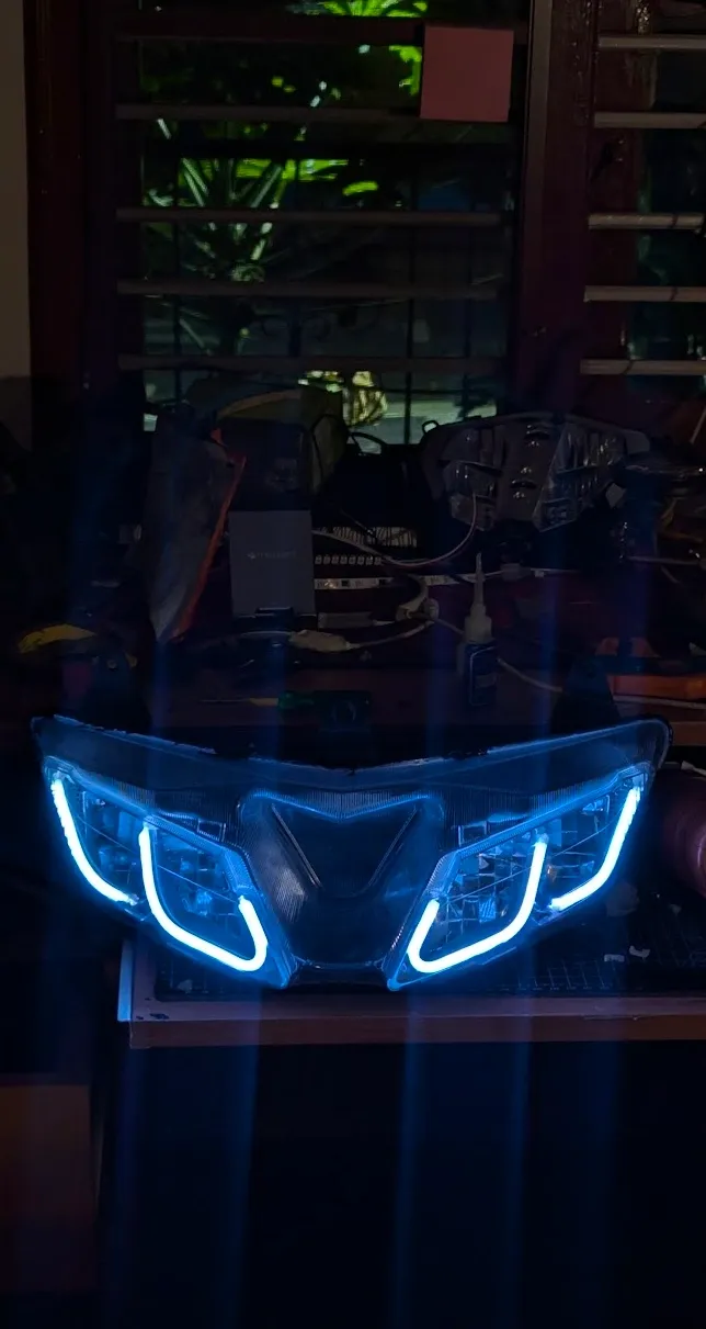 Custom motorcycle headlight assembly with blue LED DRL strips