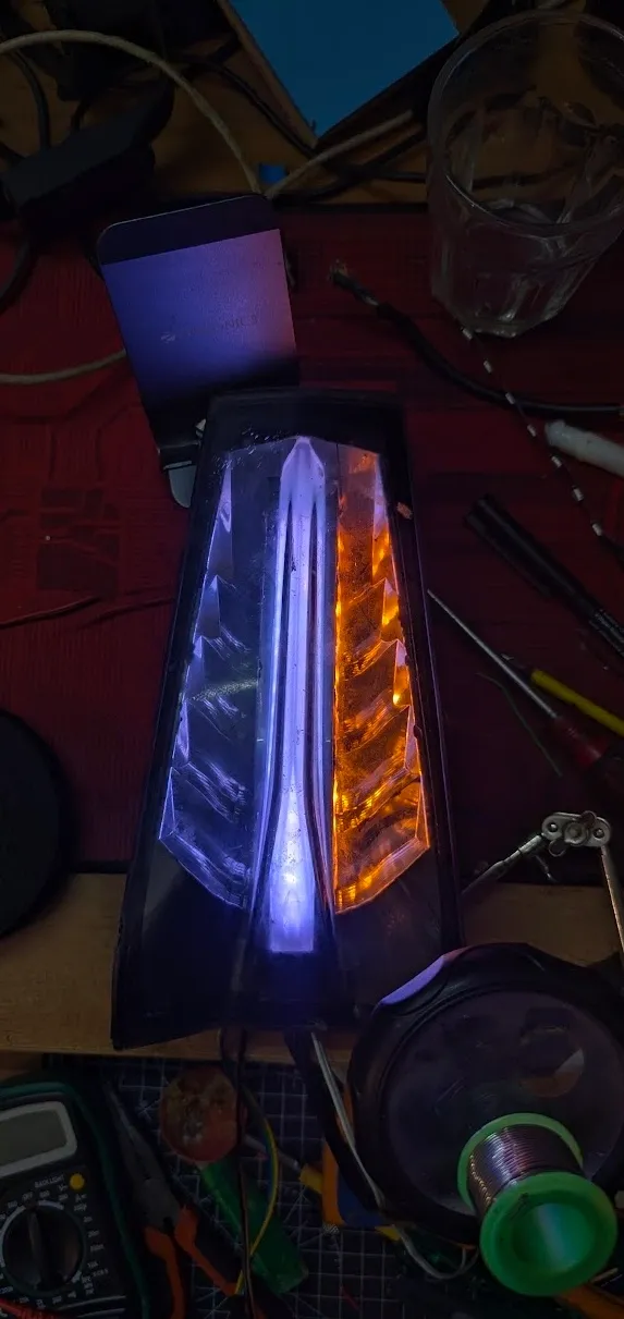 Custom LED tail light unit with white and amber LEDs on workbench