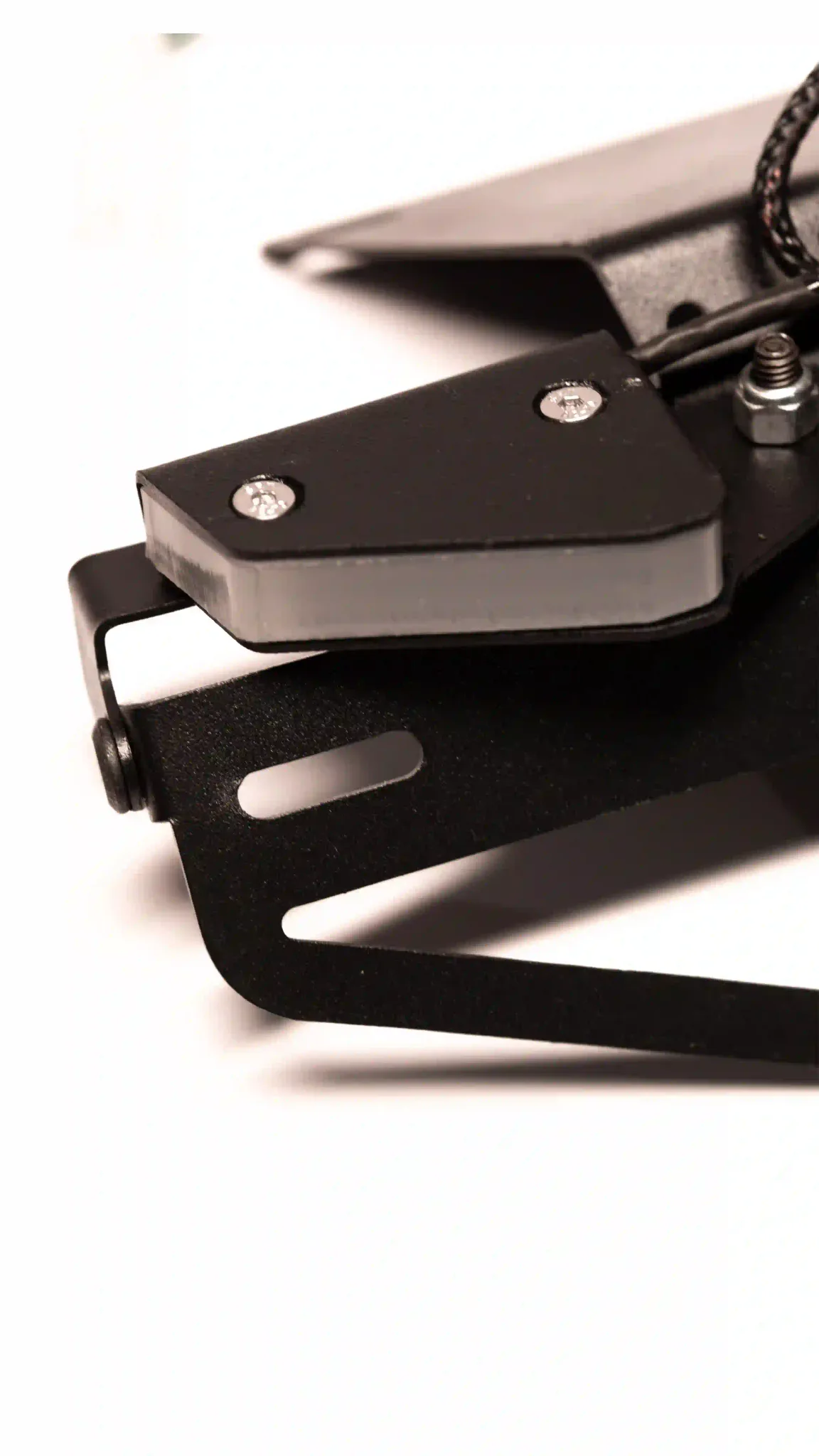 Close-up of one Split LED indicator pod secured to the black tail tidy bracket